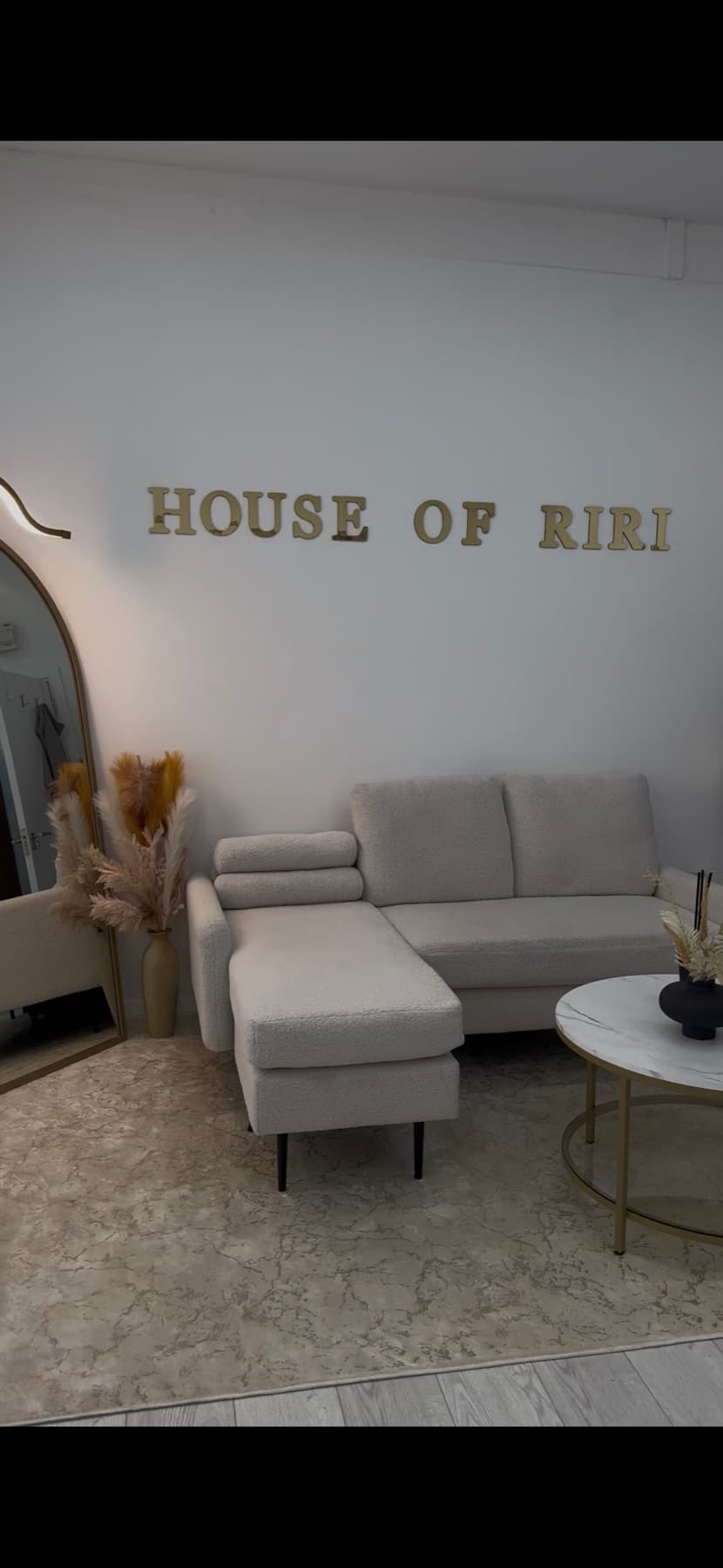 The House of Riri clinic interior, with the studio's gold wall lettering