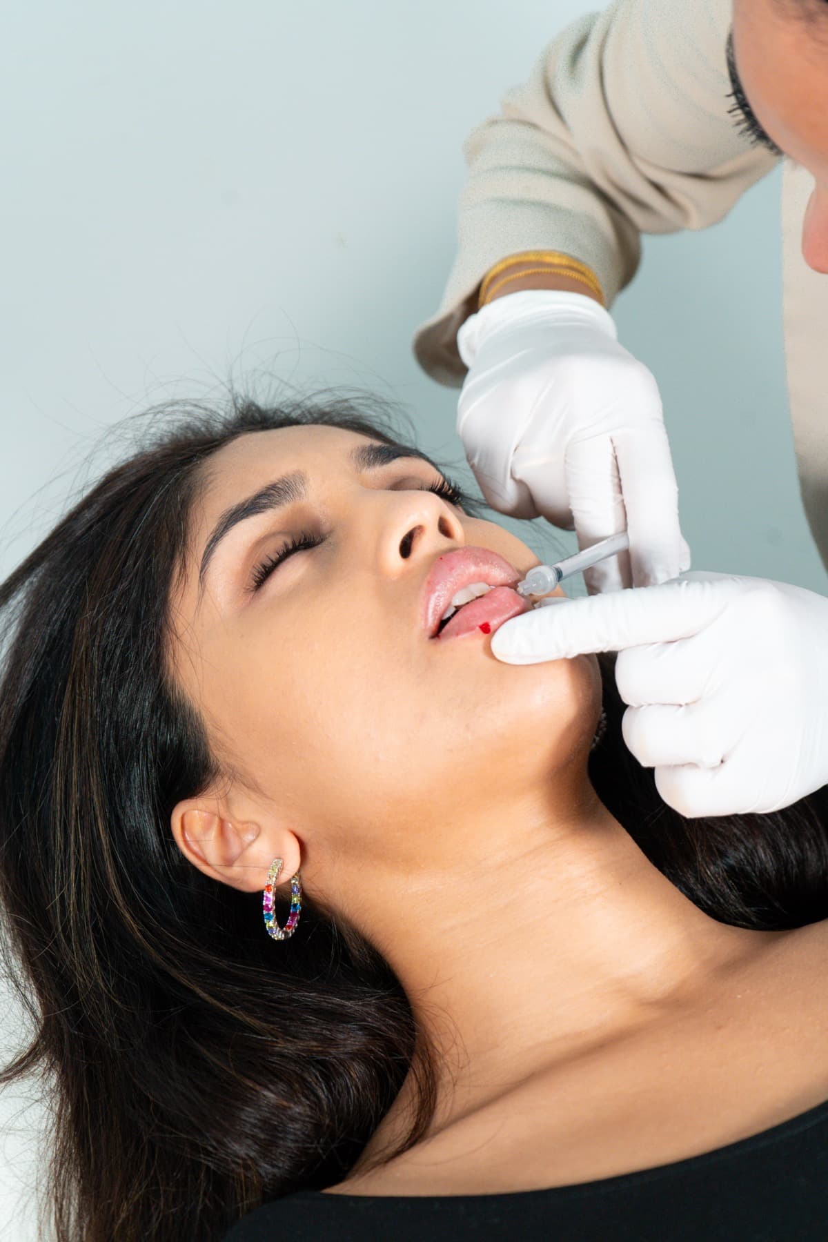 Lip filler treatment in progress at House of Riri