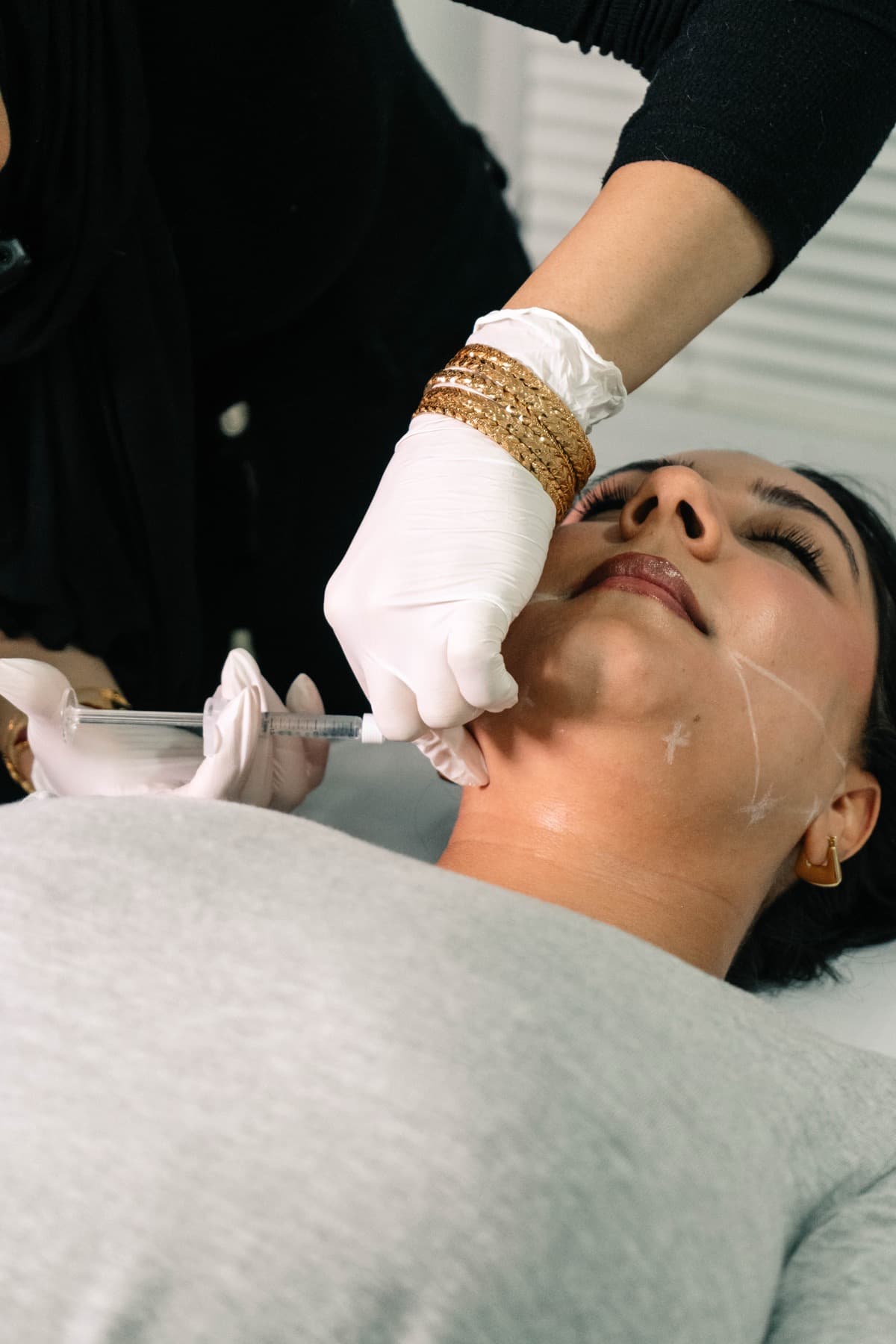 Jawline filler treatment in progress at House of Riri