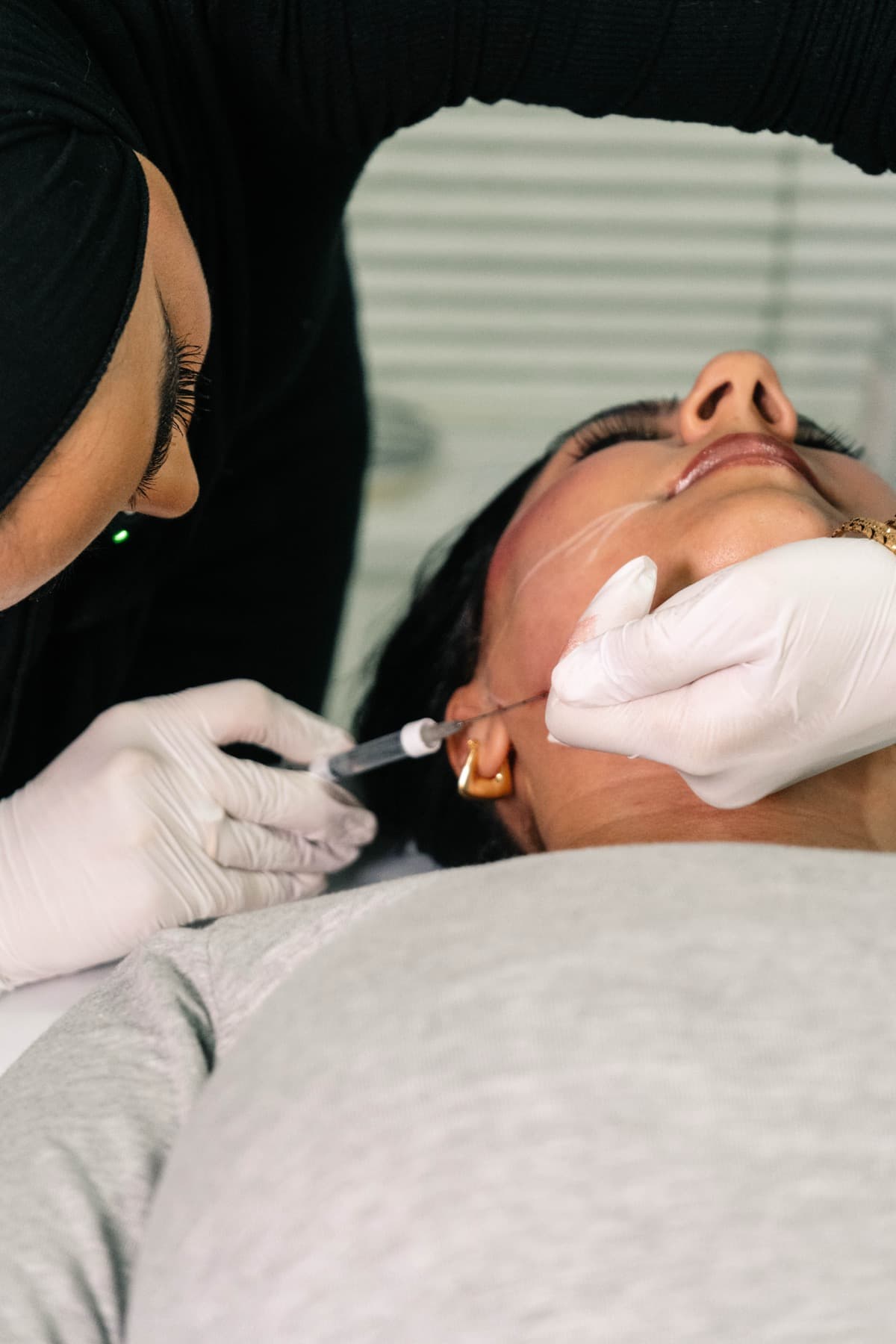 Jawline filler treatment in progress at House of Riri
