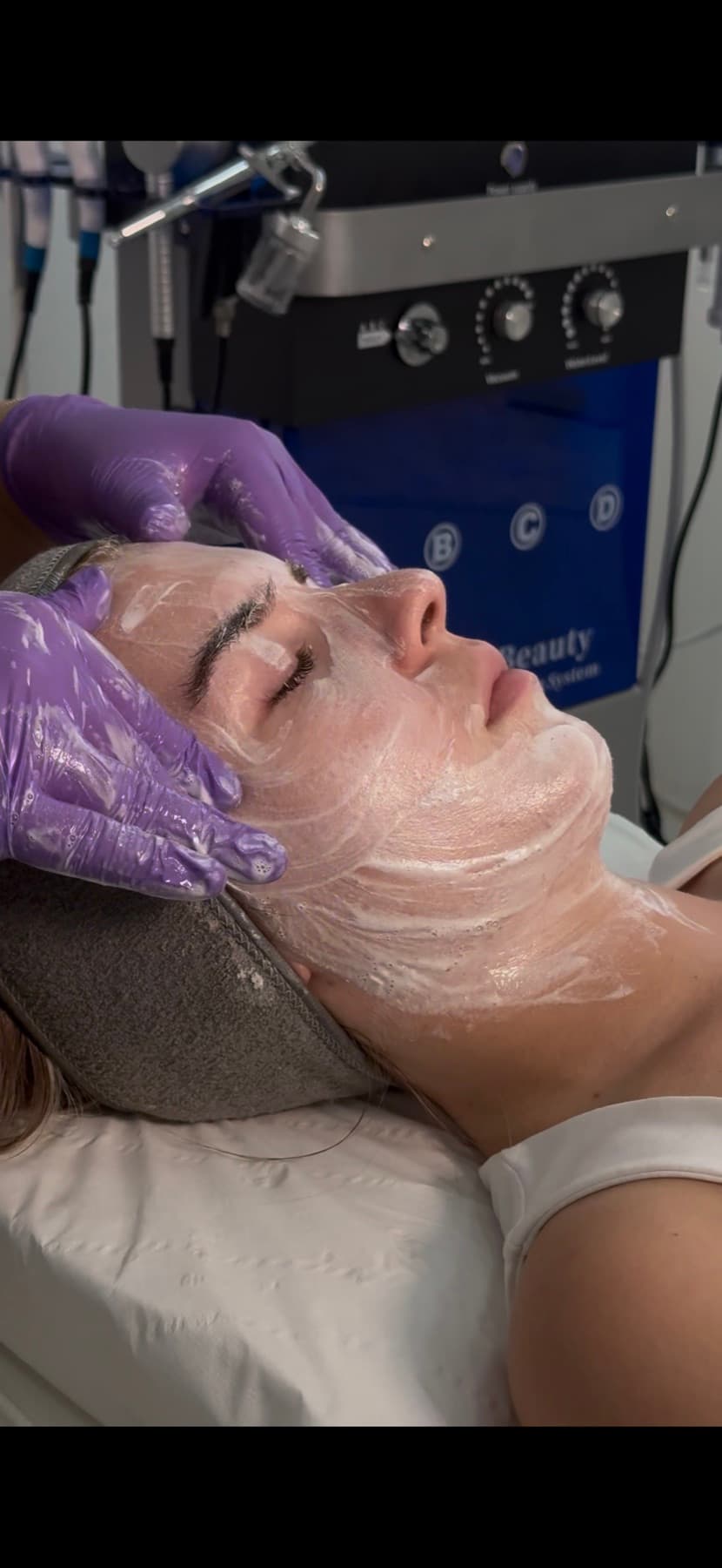 Close-up of a hydrofacial treatment device in use