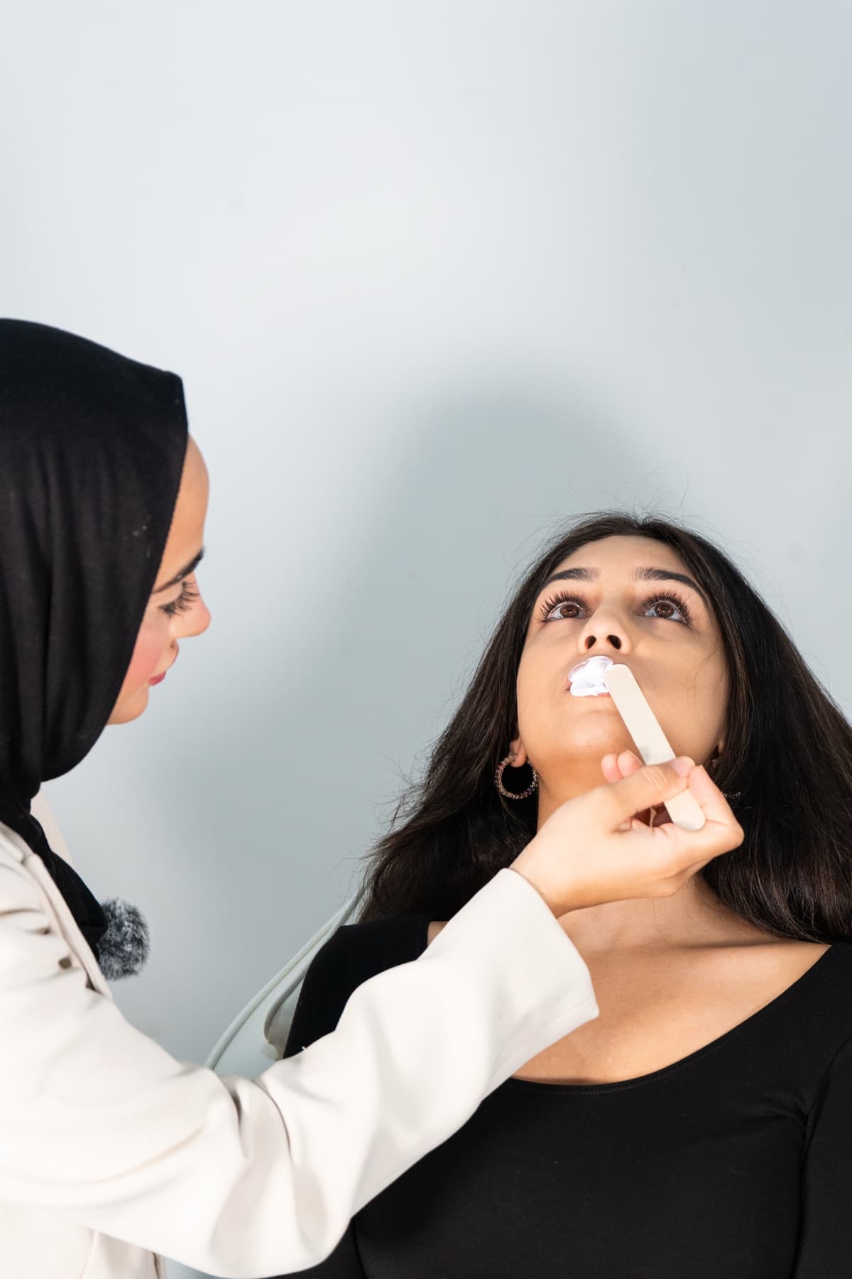 Applying numbing cream ahead of lip filler treatment