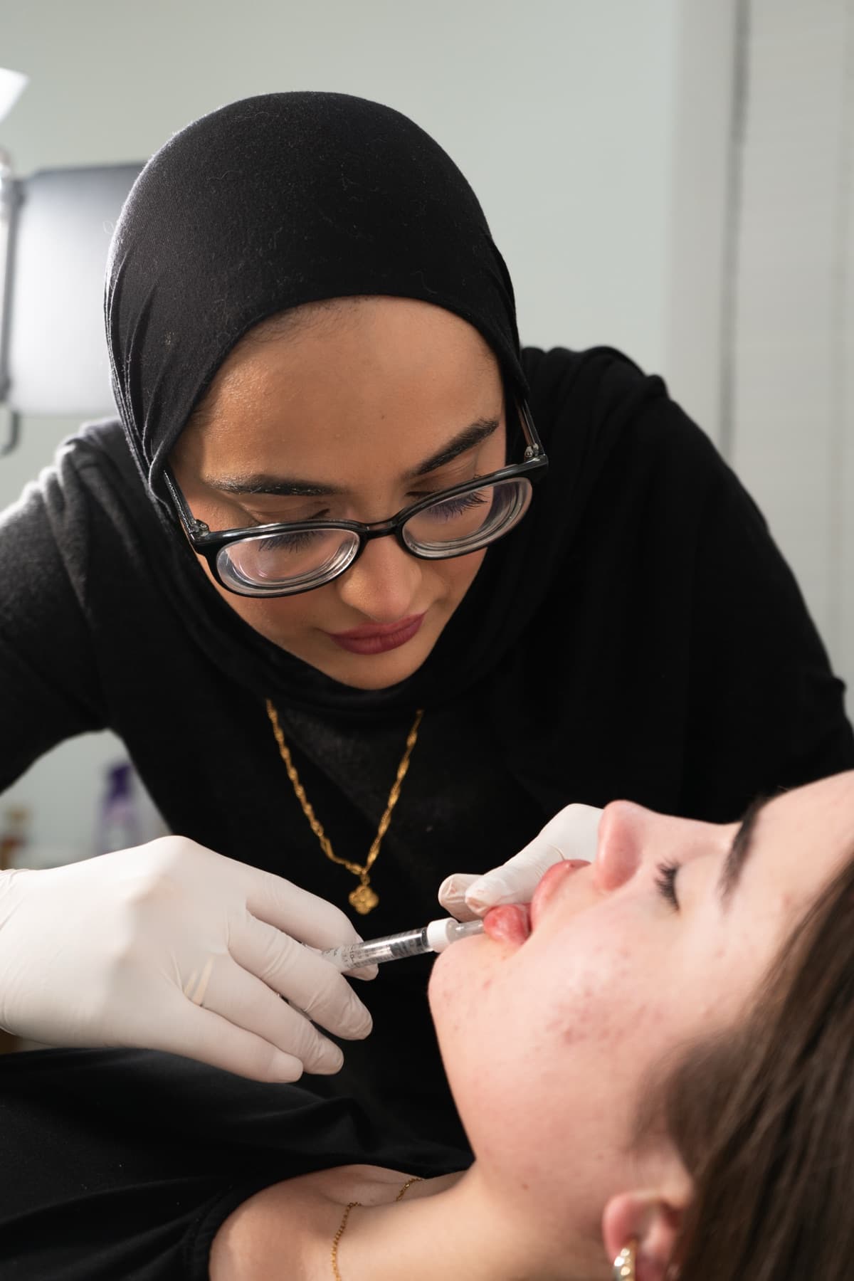 Practitioner administering lip filler at House of Riri