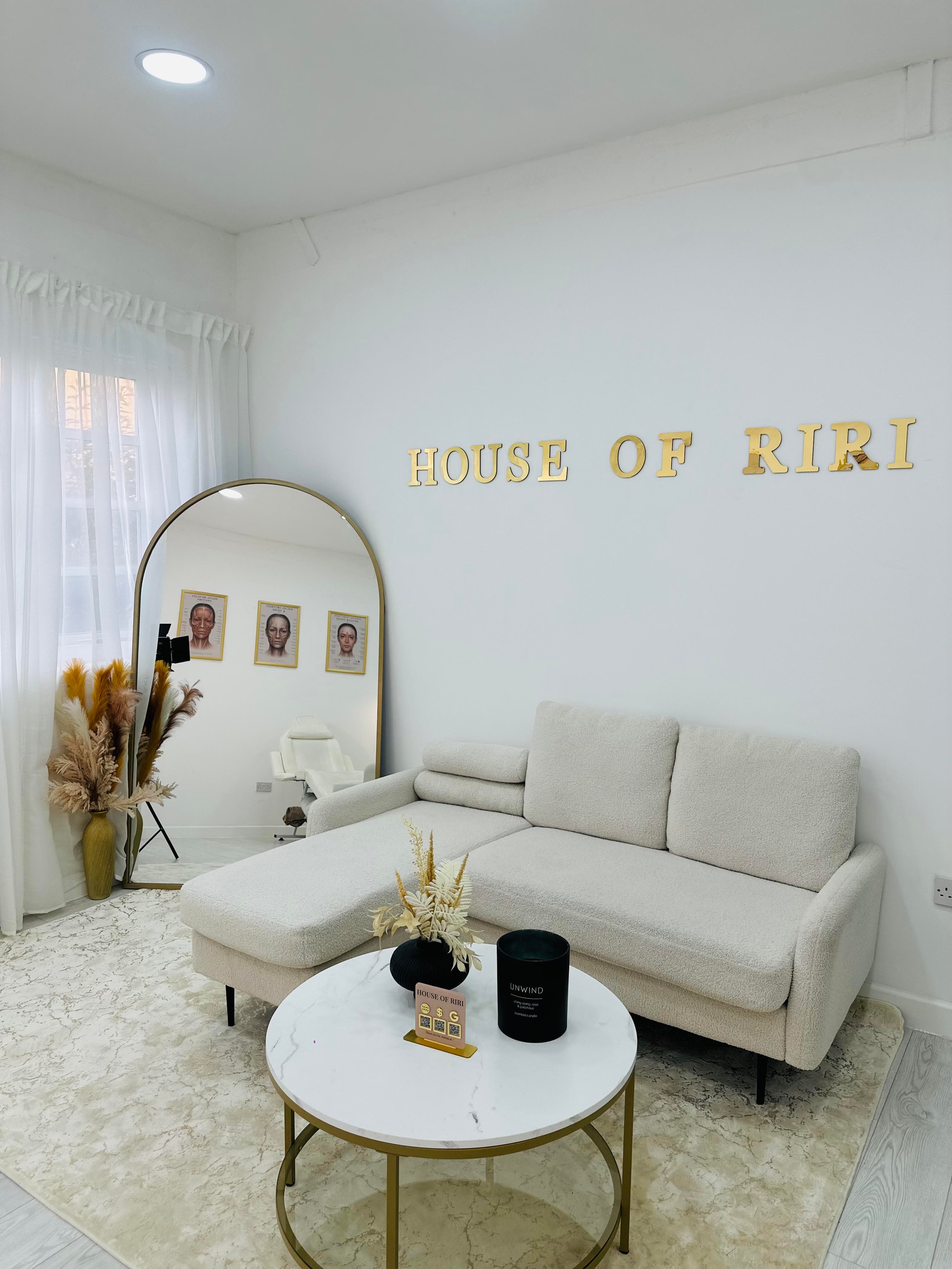 The House of Riri clinic interior, with the studio's gold wall lettering